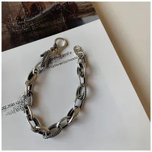 Close-up of vintage silver chain links with snake skin texture and S-hook clasp