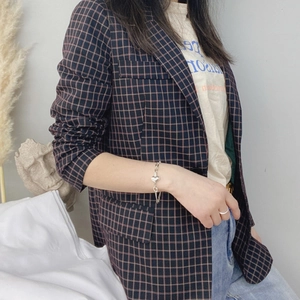 925 silver bracelet with hollow 3D heart pendant shown on model's wrist with plaid suit