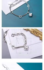 Detailed view of S925 silver bracelet featuring asymmetrical chains and heart charm