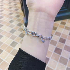 Macro shot of S925 sterling silver infinity link bracelet with OT toggle clasp and charm