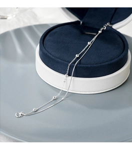 Close-up of a double-layer S925 silver bracelet featuring a smooth snake chain and beads