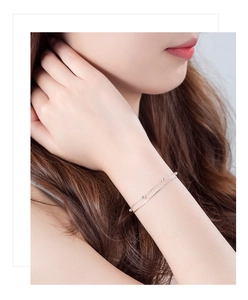 Detail of double-layer S925 silver bracelet featuring smooth beads on a layered snake chain