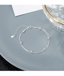 Detail of S925 sterling silver double-layer bracelet with snake chain and round beads