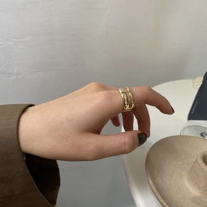 Modern double-layer wavy gold ring for women worn on index finger with a polished finish