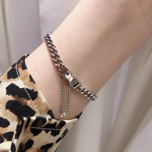 Macro view of S925 sterling silver curb chain bracelet with belt buckle clasp and safety chain