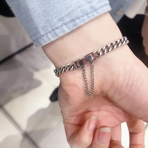 Detail of S925 sterling silver curb chain bracelet with square clasp and safety chain