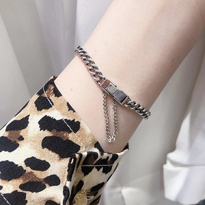 Close-up of S925 sterling silver curb chain bracelet with rectangular clasp and tassel