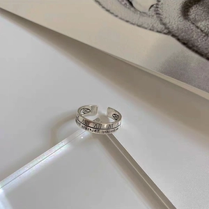 Minimalist 925 silver Mobius ring with Roman numeral engraving on acrylic prism base
