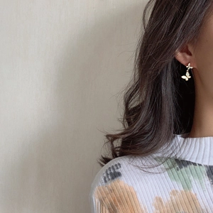 Elegant gold butterfly earrings with shell inlay and rhinestones on female model
