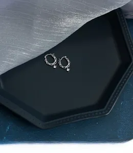 Detail of S925 sterling silver lace hoop earrings with sparkling zircon drop pendants