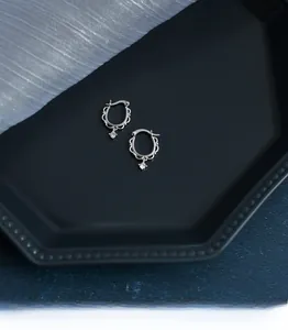 Detail of S925 sterling silver lace hoop earrings with sparkling zircon drop pendants