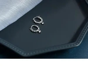 Detailed macro view of S925 sterling silver lace hoops with dangling round zirconia crystals