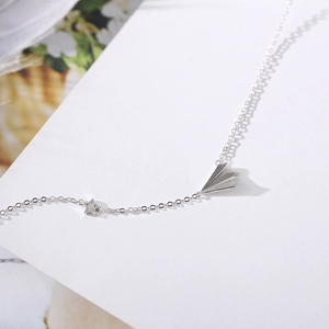 Minimalist 925 sterling silver paper plane necklace with a small sparkling star pendant