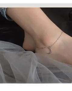 Close-up of S925 sterling silver moon anklet with micro-set zircons on female ankle