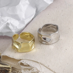Macro shot of S925 sterling silver rings with irregular hammered texture and hallmark