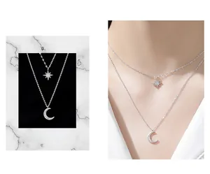 Detail of 925 sterling silver double-layer necklace with star and moon pendant