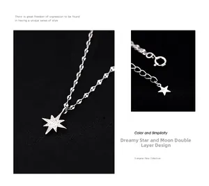 Macro shot of S925 sterling silver star pendant and layered chain detail on black fabric
