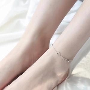 Detail of 925 sterling silver anklet with zircon circle and small heart pendants