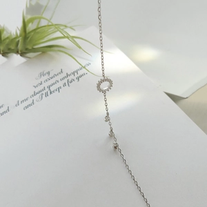 Detailed view of 925 sterling silver anklet featuring a pave-set geometric circle pendant