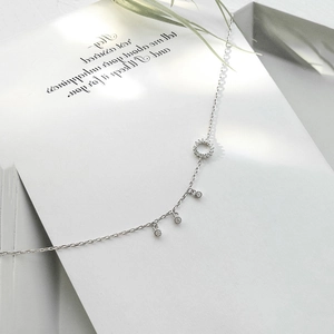 Close-up of S925 silver chain necklace featuring a pavé ring and three zircon charms
