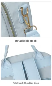 Detail of light blue backpack with detachable golden metal hooks and spliced shoulder straps