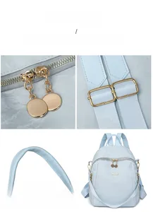 Detail of light blue oxford backpack featuring polished gold zippers and metal hardware