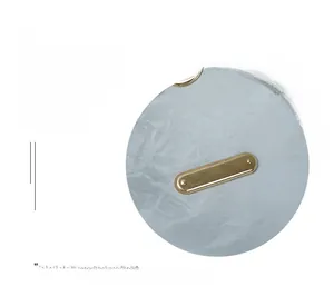 Detail of light blue oxford backpack featuring a decorative golden metal rivet detail