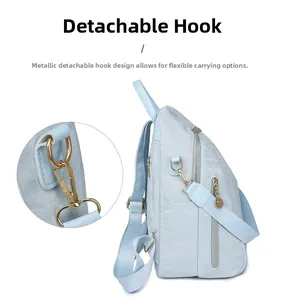 Detail of detachable golden metal hook and blue oxford fabric backpack strap