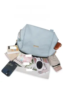 Spacious mint green oxford backpack showing organized storage for A4 books and daily items