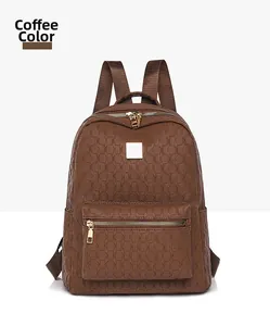 Detail view of coffee brown PU backpack featuring octagonal embossed texture and gold zipper