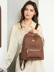 Detail of brown PU leather backpack with geometric embossing and gold hardware