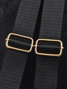 Macro detail of adjustable black nylon strap with golden metal buckle on backpack