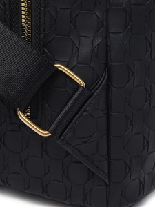 Detail of black PU backpack featuring geometric woven texture and gold metal buckle