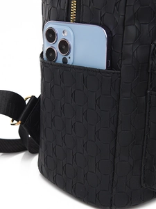 Detail of black PU leather backpack side pocket holding a smartphone for capacity
