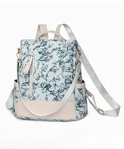Sac à dos rétro en toile fleurie avec finitions en cuir et poches latérales