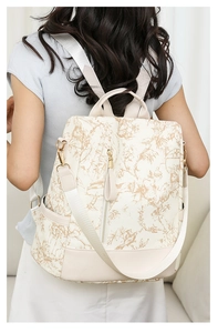 Vue arrière du sac à dos vintage en toile crème avec motifs floraux beiges élégants