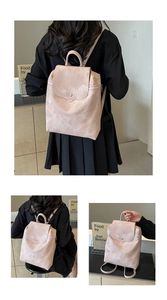 Detail view of pink marble pattern PU leather backpack with gold clasp and top handle
