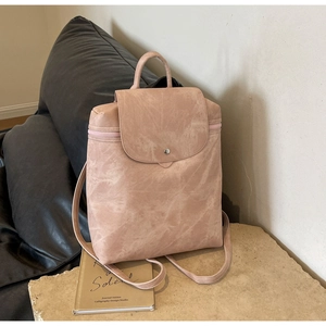 Detail view of pink PU leather backpack with vintage texture and top handle closure