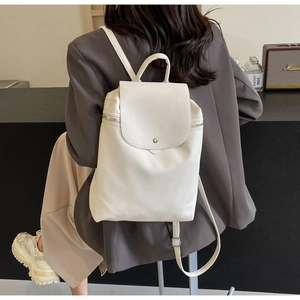 Ivory PU leather backpack with flap magnetic closure and side zipper shown on model