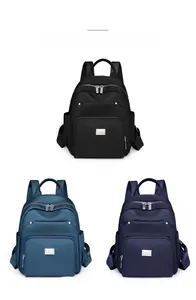Three minimalist nylon backpacks shown in black, peacock blue, and royal blue color options