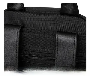 Close-up of black nylon backpack showing precision double stitching and metal zipper