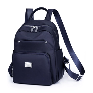 Minimalist navy blue nylon backpack with multiple pockets and silver hardware for women