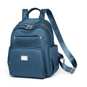Navy blue nylon backpack for women featuring multiple zipper pockets and a minimalist design