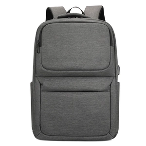 Close-up of side USB charging port on a grey waterproof business laptop backpack