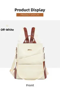 Front view of cream leather commuter backpack with geometric stitching and gold accents