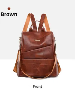 Detailed front view of brown vintage leather backpack with geometric hardware and fabric straps
