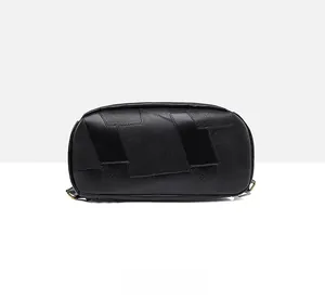 Detailed bottom view of the black leather patchwork backpack with textured panels