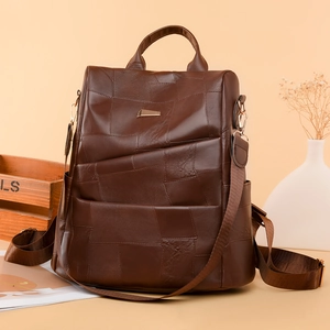 Detail of dark brown patchwork backpack with geometric soft synthetic leather panels