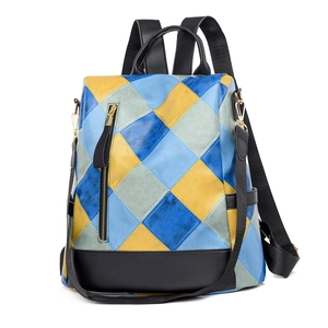 Detail of the blue yellow and grey diamond quilted pattern with metallic zipper