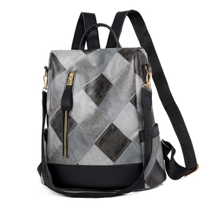 Detail view of anti-theft women's backpack with gray leather diamond quilting and gold hardware
